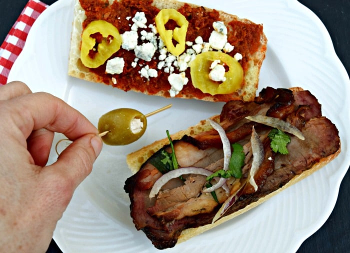 beef-brisket-sandwich-holding-olive