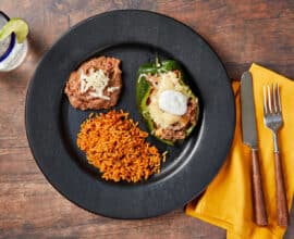 Beef Picadillo Stuffed Peppers with Mexican Rice and Refried B...
